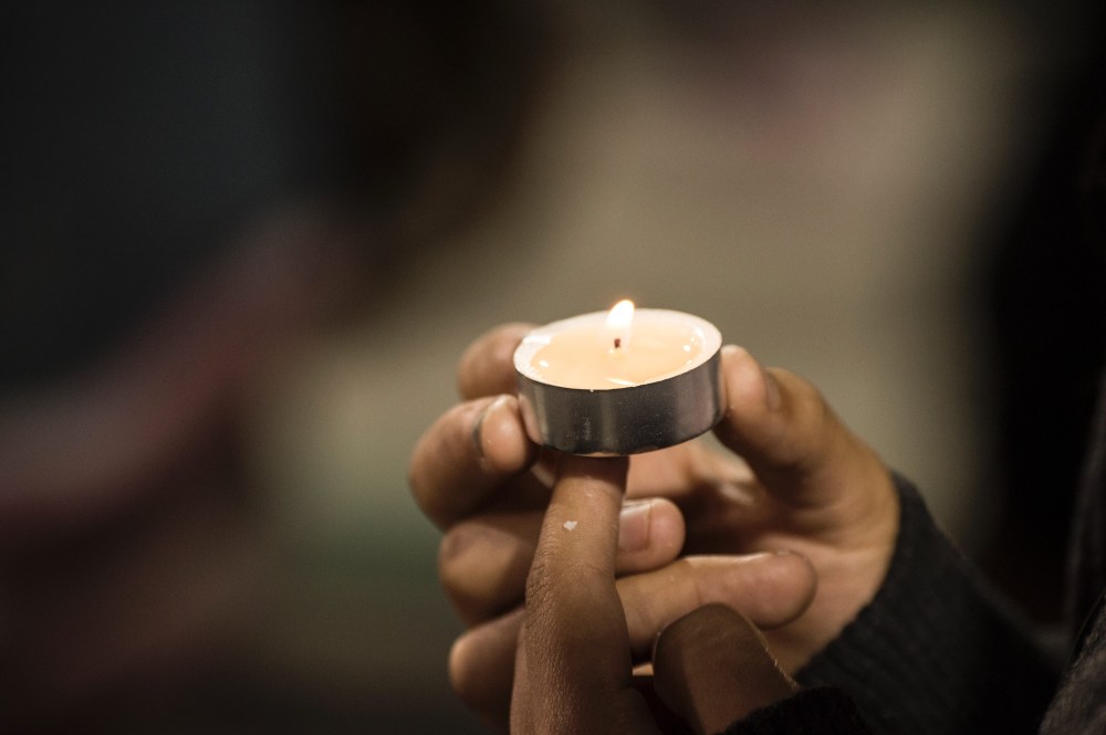 People attend a candlelight vigil at the San Manuel Stadium in San Bernardino, Calif., Dec. 3, 2015 for victims of the Dec. 2 mass shooting in San Bernardino which left 14 dead and at least 17 injured. (Photo by Robyn Beck/AFP/Getty)