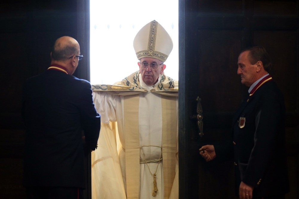 Pope Francis opens the Holy Door of St. Peter's Basilica on Dec. 8, 2015 in Vatican City, Vatican. (Photo by Vatican Pool/Getty)