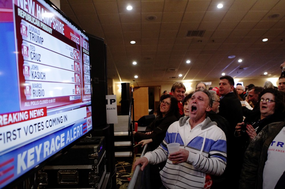 Trump supporters cheer as a television screen shows early poll numbers at Trump's election night rally on Feb. 9, 2016 in Manchester, N.H. (Photo by Matthew Cavanaugh/Getty)