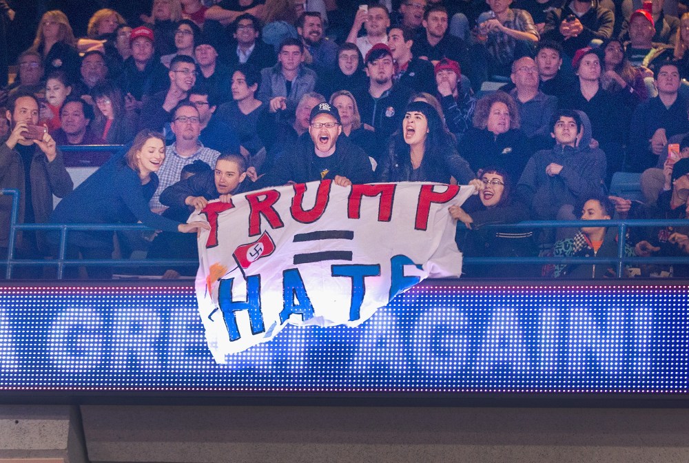 Demonstrators react after learning a rally for Republican presidential candidate Donald Trump at the University of Illinois at Chicago would be postponed on March 11, 2016 in Chicago, Ill. (Photo by Scott Olson/Getty)