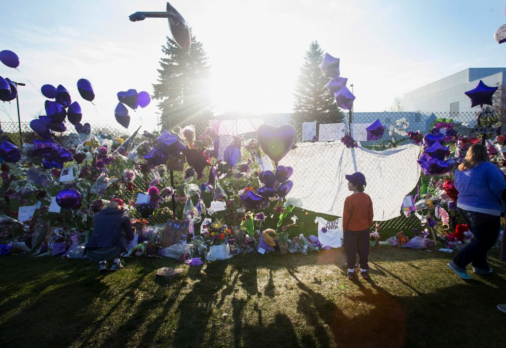 Music fans visit a memorial created outside Paisley Park, the home and studio of Prince, on April 23, 2016 in Chanhassen, Minn. (Photo by Scott Olson/Getty)