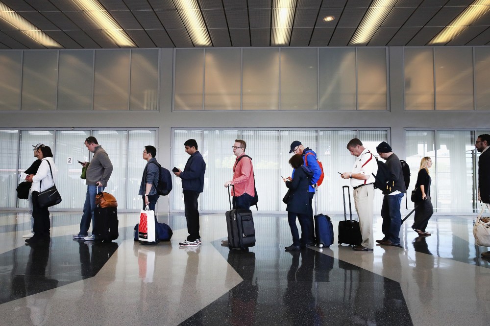 Passengers at O'Hare International Airport wait in line to be screened at a Transportation Security Administration (TSA) checkpoint on May 16, 2016 in Chicago, Ill. (Photo by Scott Olson/Getty)