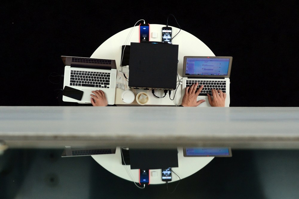 Users type on laptop computers during an event in Los Angeles, Calif., on Nov. 18, 2014. (Photo by Frederic J. Brown/AFP/Getty)