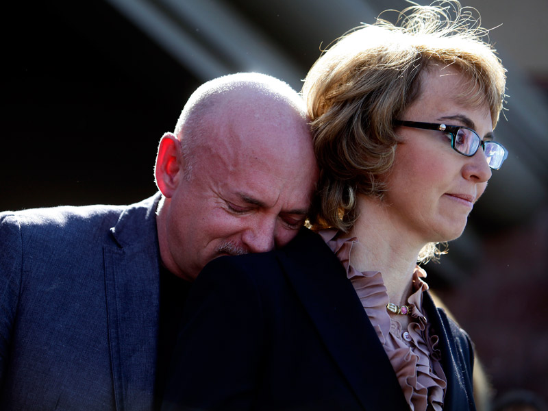 Mark Kelly leans his head on the shoulder of his wife and former congresswoman Gabby Giffords at a in Tucson, Arizona on March 6, 2013. (Photo by Joshua Lott/Getty Images)