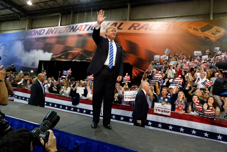 Republican presidential hopeful Donald Trump waves to a group of supporters as he attends a campaign rally in Richmond, Va., Oct. 14, 2015. (Photo by Steve Helber/AP)