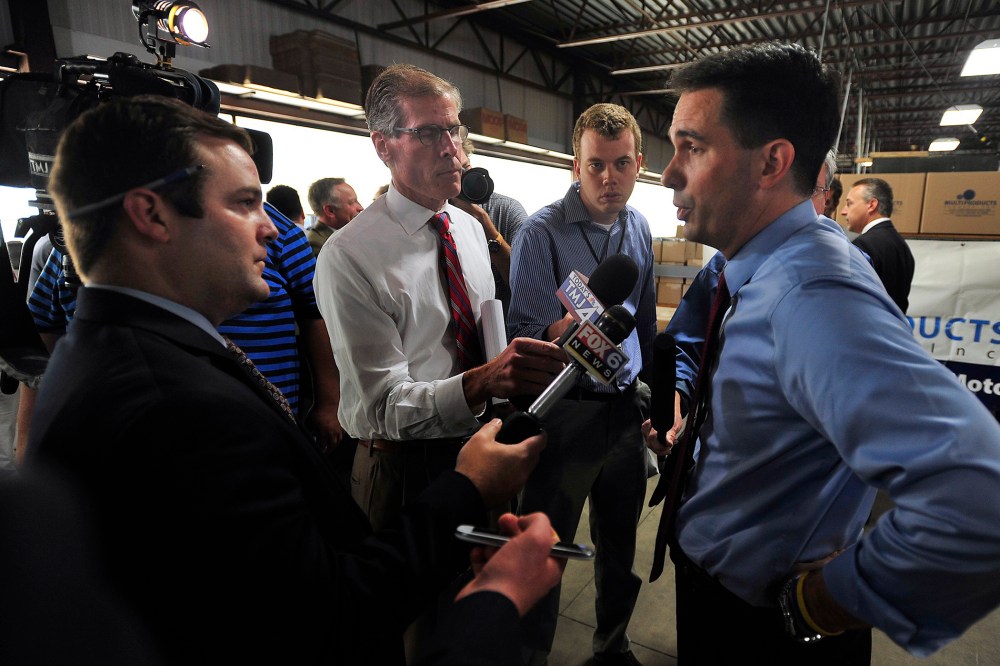 Gov. Scott Walker answers questions from print and television reporters during a campaign stop and tour at Multi Products Company, Inc. near Racine, Wisc. on Sept. 23, 2014.