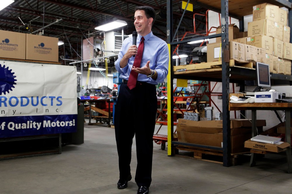 Republican Wisconsin Gov. Scott Walker campaigns for re-election at a manufacturing company in Racine, Wis. on Sept. 23, 2014.