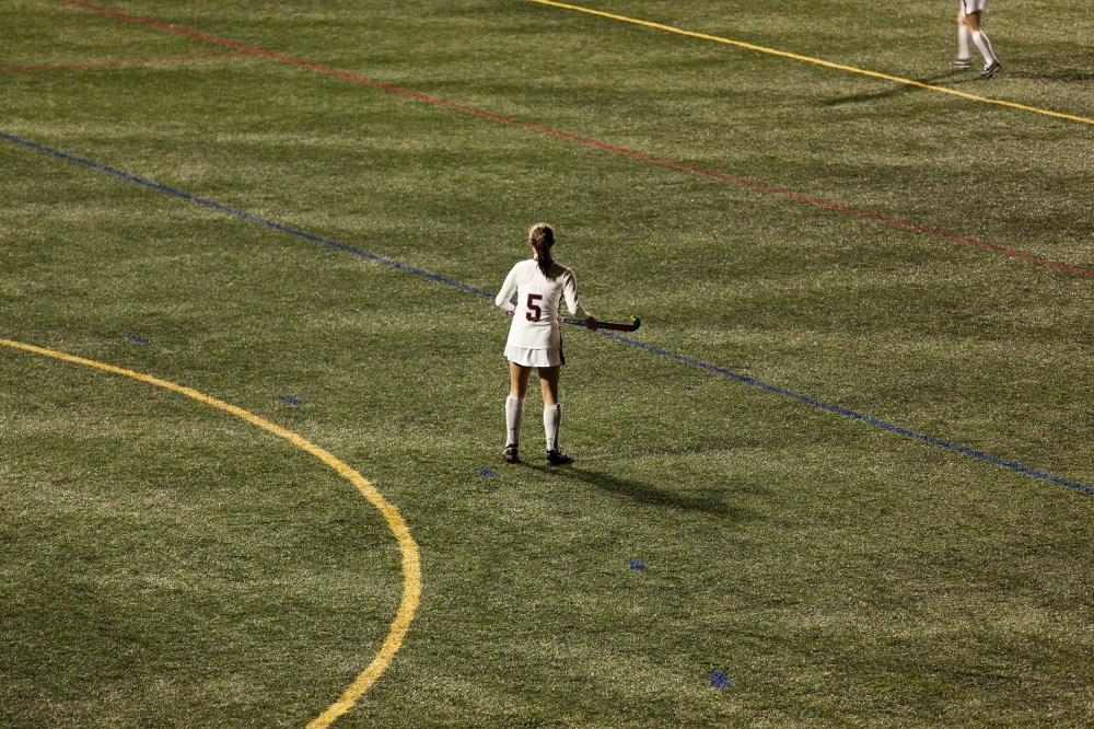 Woman playing field hockey.