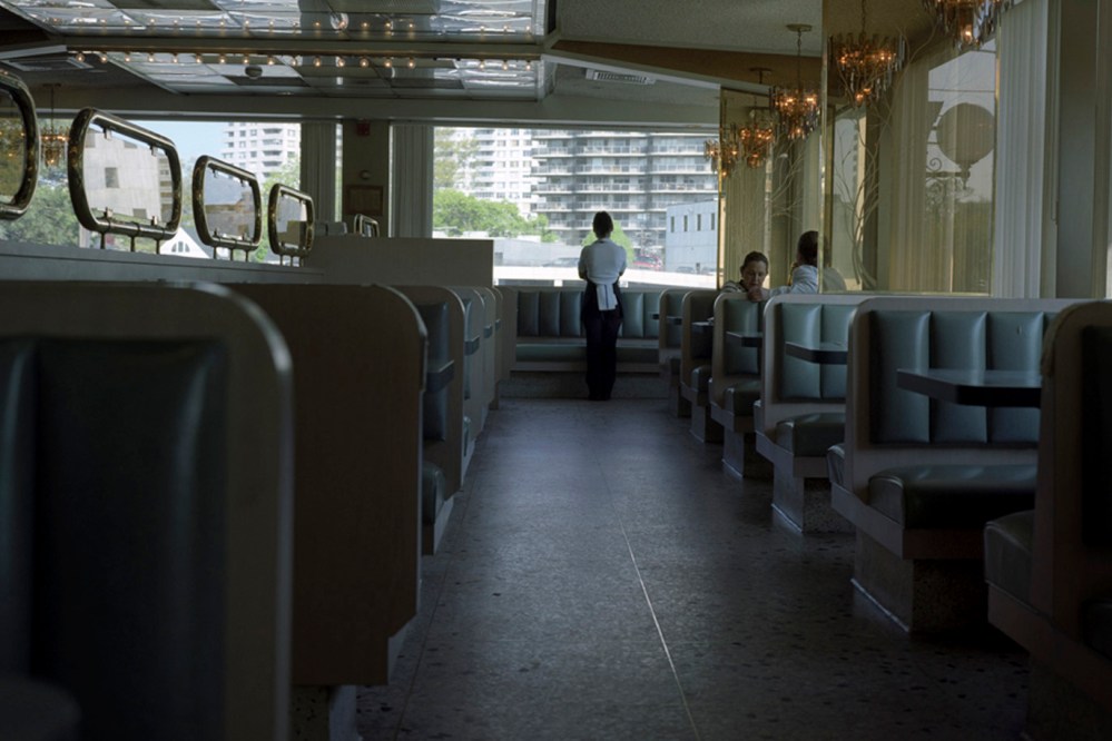 A waitress looks out the window of a diner in Fort Lee, N.J. (Photo by Kelly Shimoda/Redux)