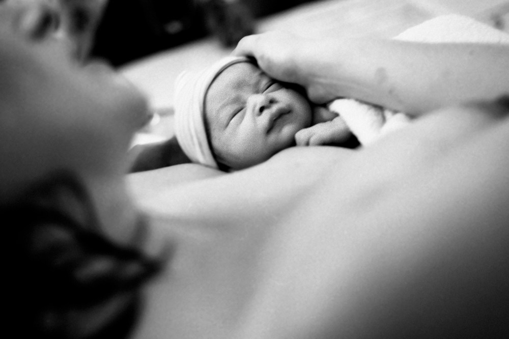 A mother holding a baby.