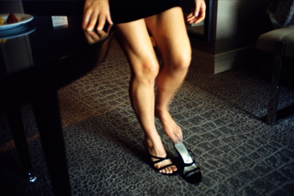 An escort slips into a high heel shoe in Washington D.C.