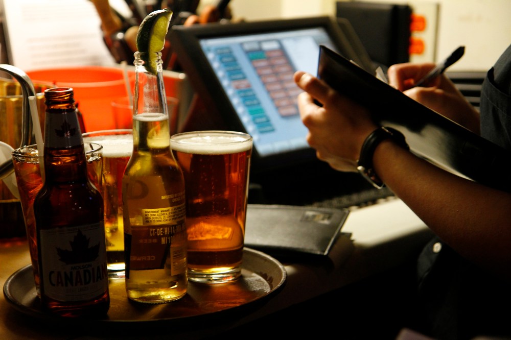 A server at a restaurant in Boston, Mass. (Photo by Mark Peterson/Redux)