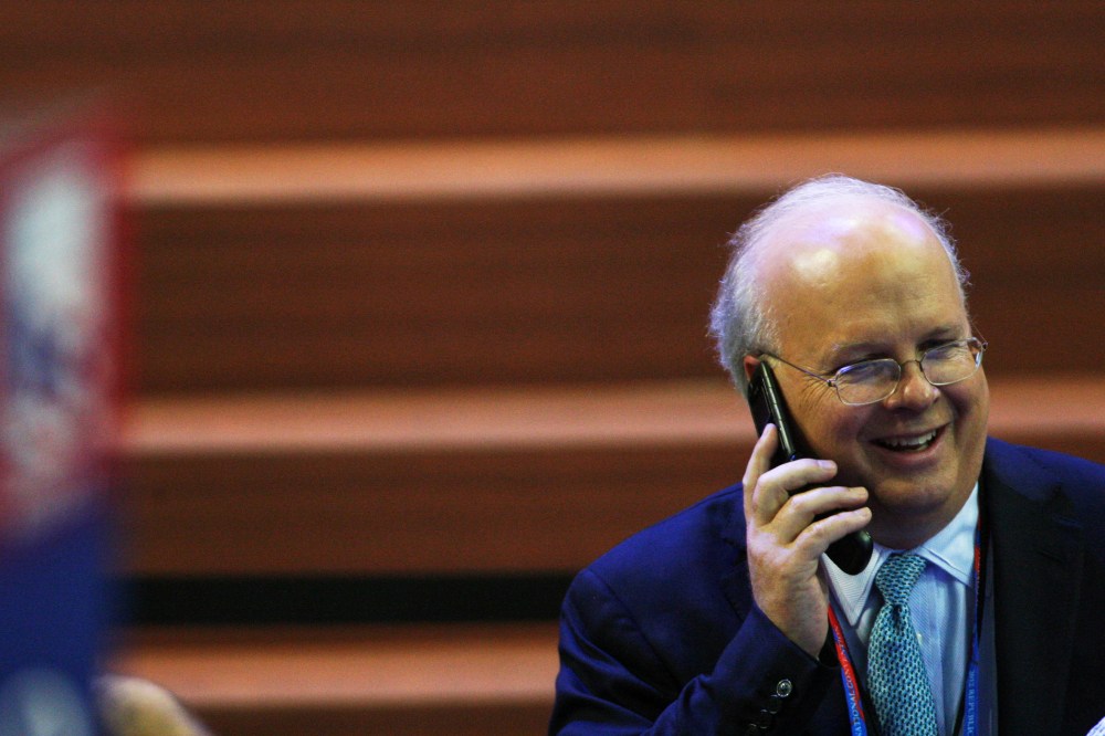 Karl Rove speaks on a cellphone during the Republican National Convention at the Tampa Bay Times Forum.