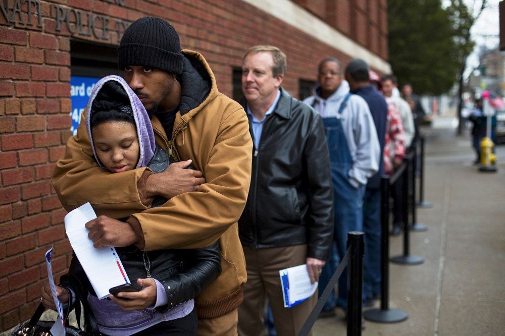 Mykia Eubanks and Jay Gwinn wait in line to vote early in downtown Cincinnati.