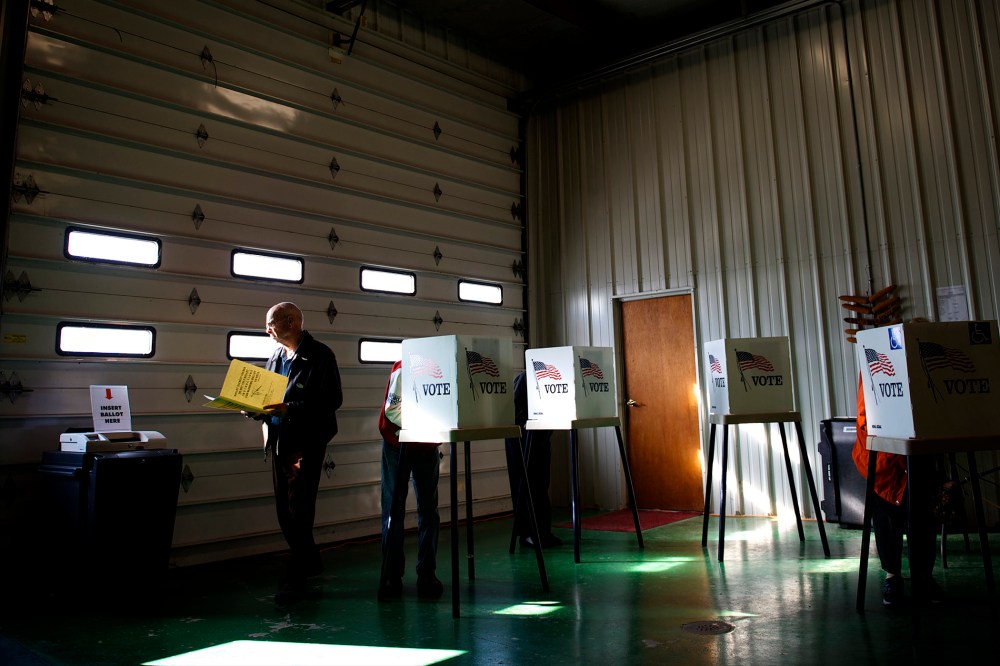 Voters cast ballots at a polling station at Ray Lounsberry's shed in Nevada Township, Iowa on Election Day, Nov. 6, 2012