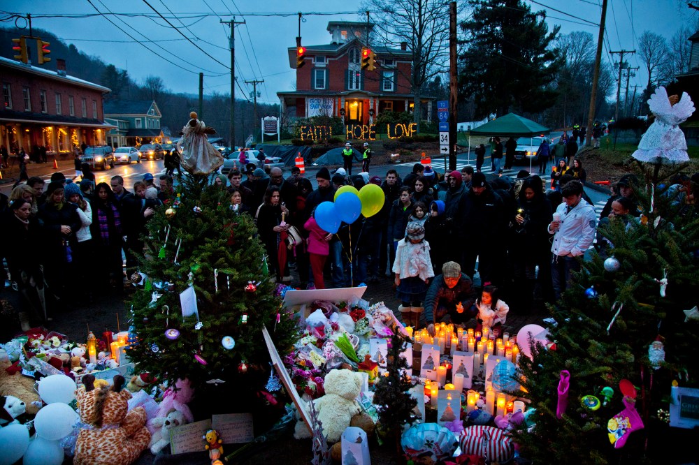 People gather and mourn at makeshift memorial set up around Newtown, Conn. on Dec. 16, 2012 for the victims of the shootings at Sandy Hook Elementary School. (Photo by Mark Peterson/Redux)
