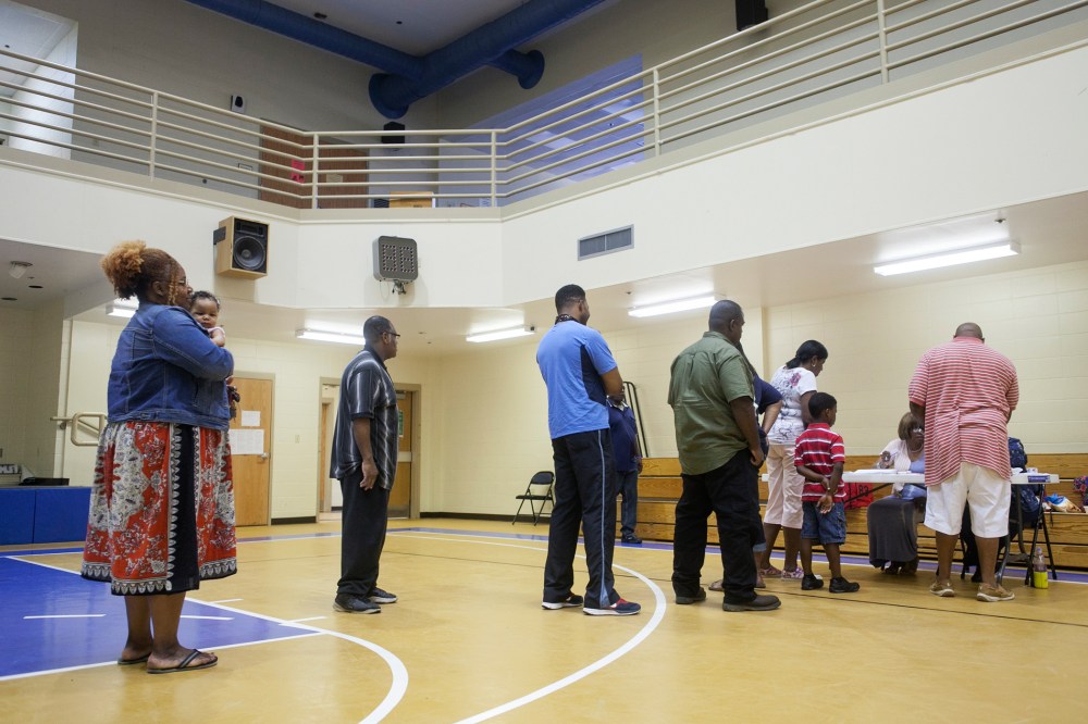Voters wait in line to cast their ballot in a Republican primary runoff at the New Hope Baptist Church in Jackson, Miss., June 24, 2014.