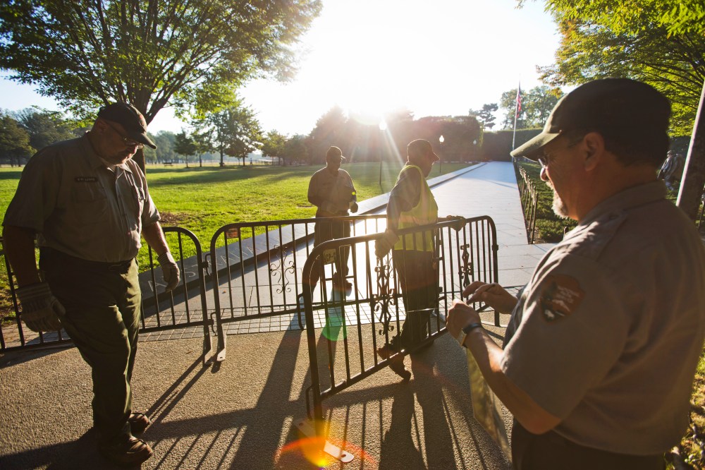 Workers with the National Park Service close the Korean War Veterans Memorial to visitors on the second day of a partial government shutdown in Washington, DC, October 2, 2013.