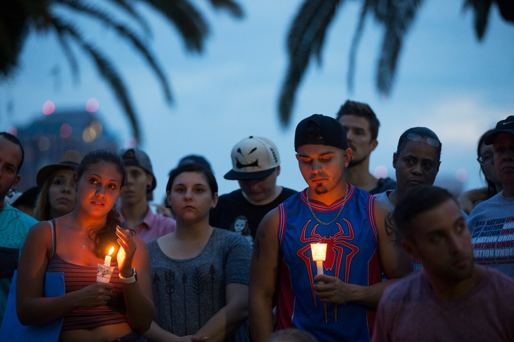 Community members gather for a vigil to honor the victims of a mass shooting at a nightclub, at Eola Lake Park in Orlando, Fla., on June 12, 2016. (Photo by Ryan Stone/EPA)