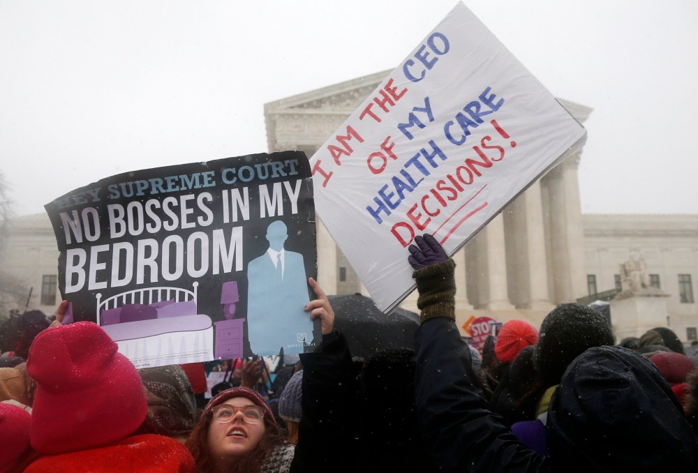 Demonstrators gather in front of the Supreme Court in Washington, Tuesday, March 25, 2014.