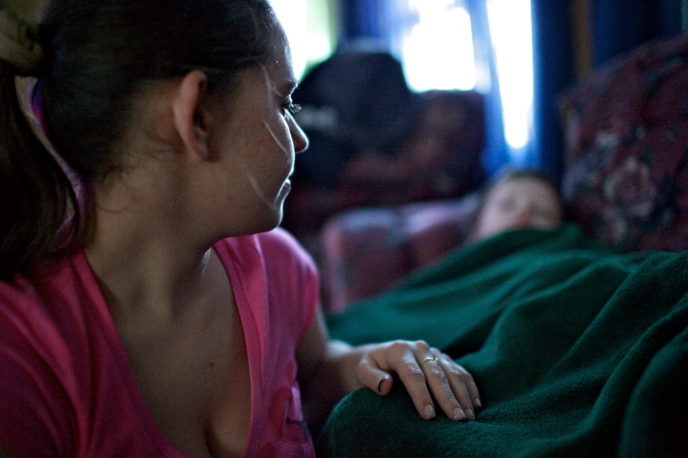 Alicia, a mother in Johnstown, Pa., tucks her two sons after returning home from working the night shift at a senior citizen home.  Alicia has two young boys and her boyfriend does not work, making her the sole provider for her family.