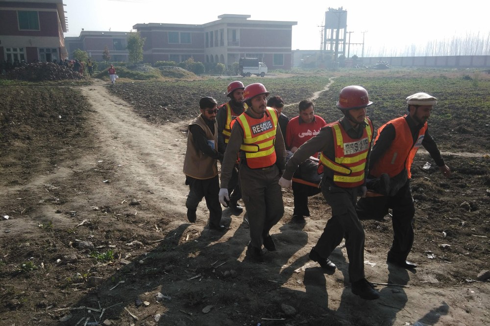 Pakistani rescuers shift an injured victim outside the Bacha Khan university following an attack by gunmen in Charsadda, about 50 kilometres from Peshawar, on Jan. 20, 2016. (Photo by A Majeed/AFP/Getty)