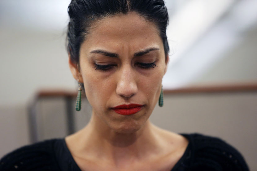Huma Abedin, wife of Anthony Weiner, a leading candidate for New York City mayor, listens as her husband speaks at a press conference on July 23, 2013 in New York City. (Photo by John Moore/Getty Images)
