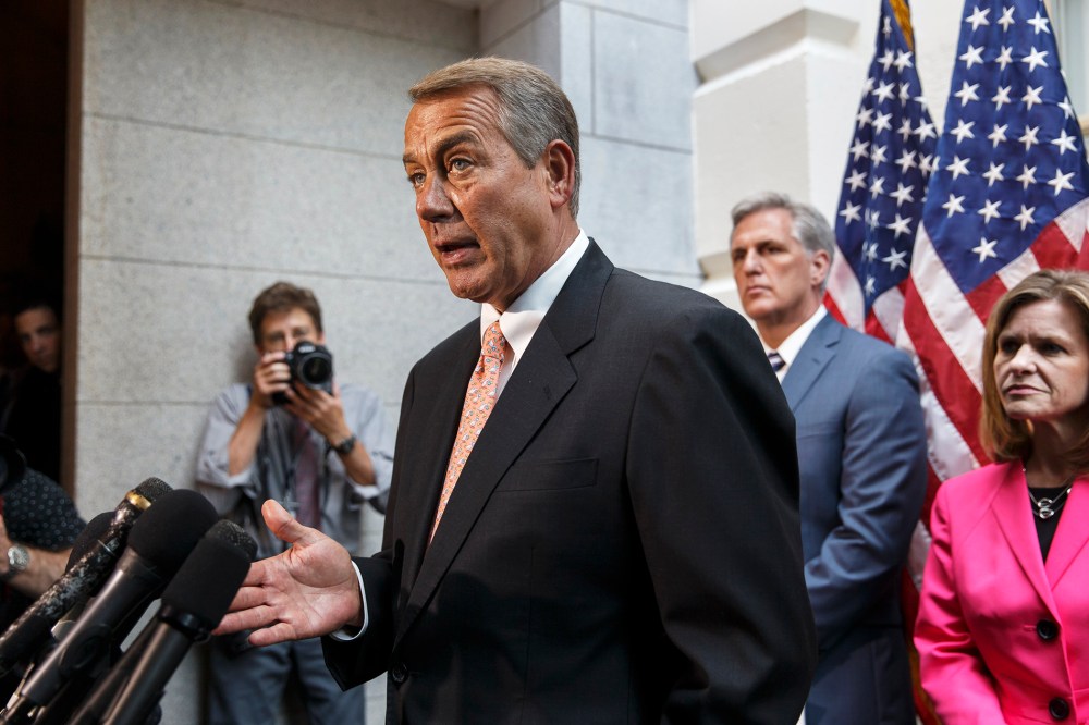 John Boehner talks with reporters on Capitol Hill in Washington, Wednesday, July 23, 2014, following a Republican strategy session.