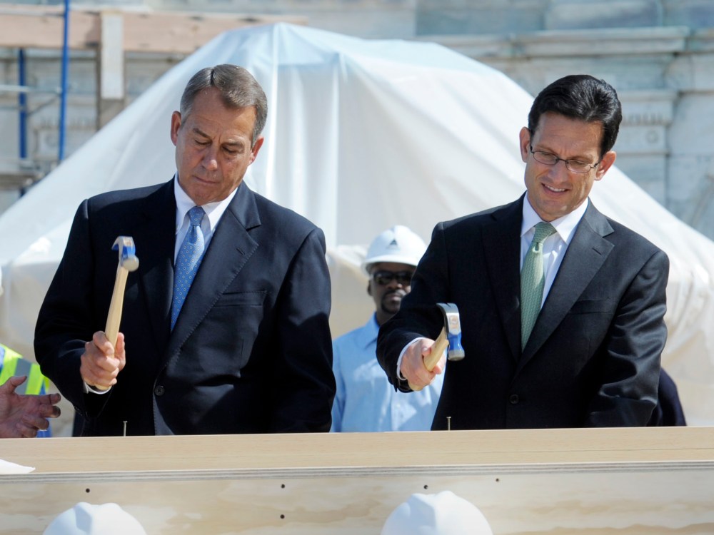 FILE PHOTO: Speaker of the House John Boehner, R-Ohio, left, House Majority Leader Eric Cantor, R-Va., right, hammer nails into a plank during the First Nail Ceremony for the official launch of construction of the Inaugural platform where the President...