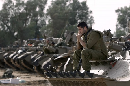 Israeli soldiers with armored vehicles gather in a staging ground near the border with the Gaza Strip in southern Israel on Friday, Nov. 16, 2012. (Photo: AP/Tsafrir Abayov)