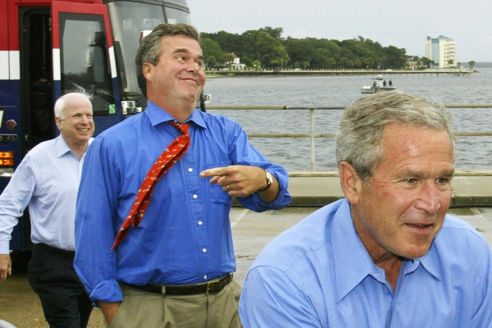 US President George W. Bush, followed by