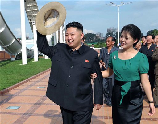 FILE - In this July 25, 2012 file photo released by the Korean Central News Agency and distributed in Tokyo by the Korea News Service, North Korean leader Kim Jong Un, accompanied by his wife Ri Sol Ju, waves to the crowd as they inspect the Rungna...
