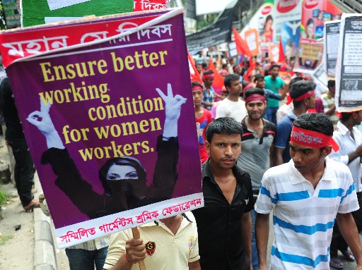 Bangladeshi activists hold placards during a procession to mark May Day or International Workers Day in Dhaka on May 1, 2013. Tens of thousands of Bangladeshis joined May Day protests Wednesday to demand the execution of textile bosses over the...