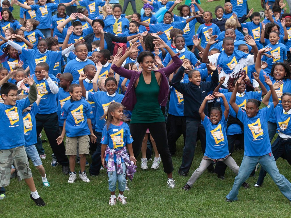 First lady Michelle Obama hosts local children on the South Lawn of the White House in Washington, Tuesday, Oct. 11, 2011, as they attempt to break the Guinness World Records title for the most people doing jumping jacks in a 24-hour period. (Photo by...