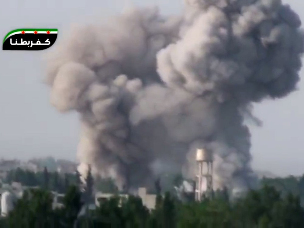 In this image taken from video obtained from the Ugarit News, which has been authenticated based on its contents and other AP reporting, smoke billows from a government airstrike on the Ghouda area of Damascus, Syria, Friday, May 3, 2013. Syria's main...