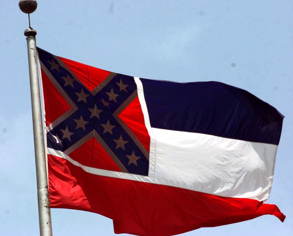 The Mississippi flag, photographed at the Capitol in Jackson, has been compared to a "badge of slavery," by civil rights groups. (Photo by Rogelio Solis/AP)