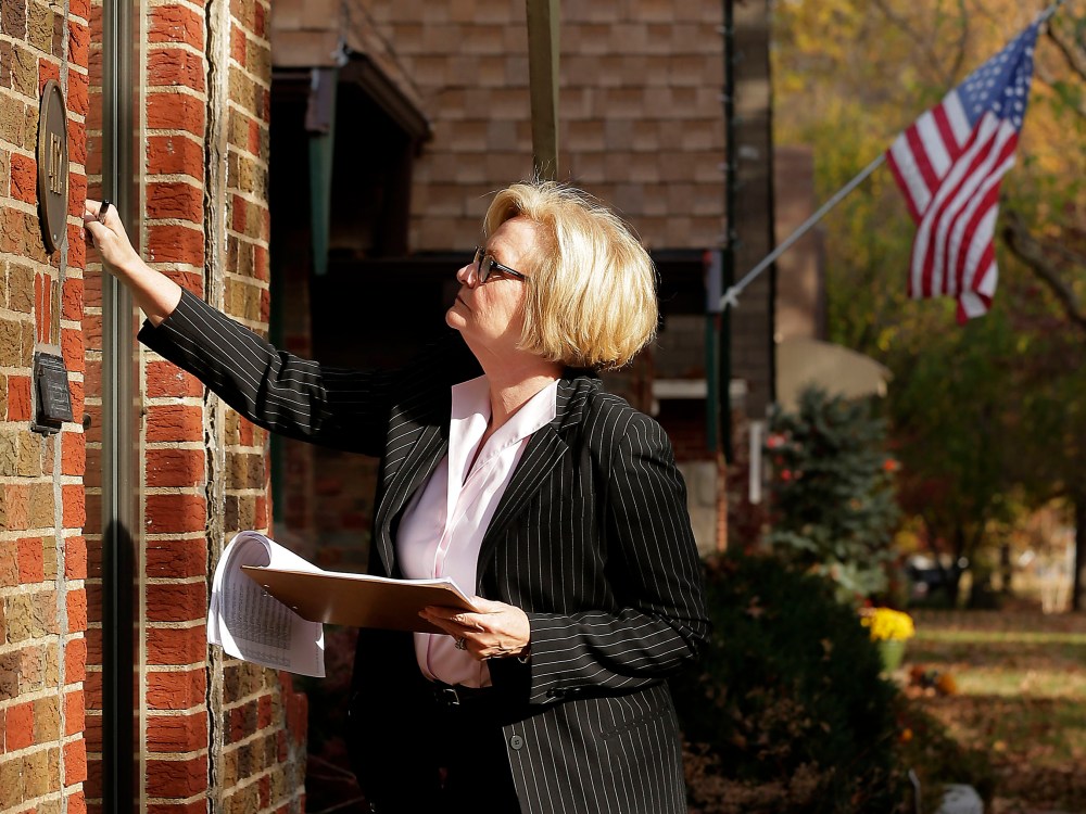 Democratic Sen. Claire McCaskill knocks on a door as she canvasses a neighborhood Friday, Nov. 2, 2012, in Kansas City, Mo. McCaskill is running against Republican Todd Akin for Missouri's Senate seat. (Photo by Charlie Riedel/AP Photo)