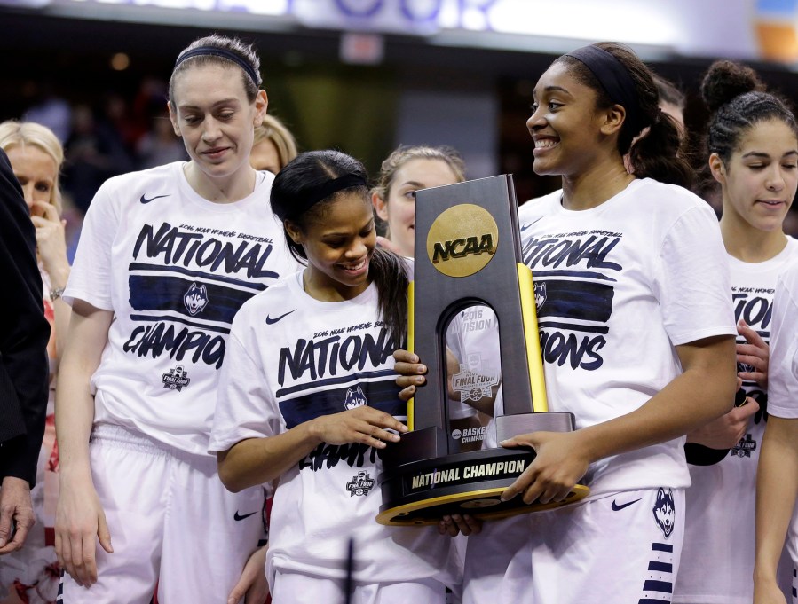 Connecticut's Breanna Stewart, left, Moriah Jefferson, center, and Morgan Tuck celebrate after defeating Syracuse in the championship game at the women's Final Four in the NCAA college basketball tournament, April 5, 2016, in Indianapolis.