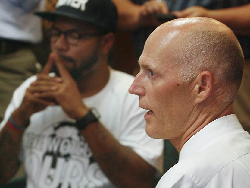 Florida Gov. Rick Scott speaks to protestors Thursday July 18, 2013 in the Capitol in Tallahassee, Fla. Florida Gov. Rick Scott is telling protesters that he will not ask lawmakers to revamp the state's self-defense laws. (Photo by Phil Sears/AP)