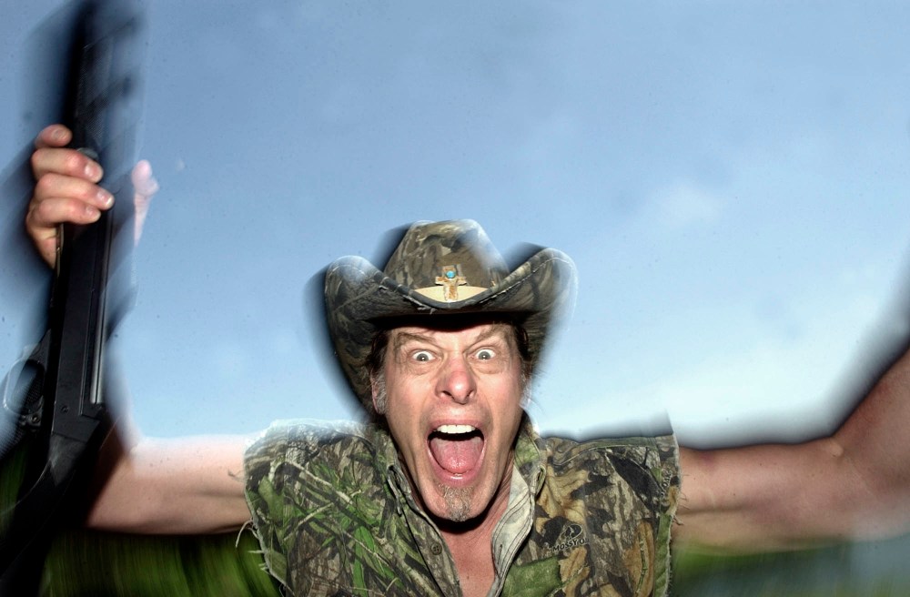 In this file photo Ted Nugent screams for a photo at his ranch near Crawford, Texas, Friday,  April 22, 2005.  (Photo by LM Otero/AP File)