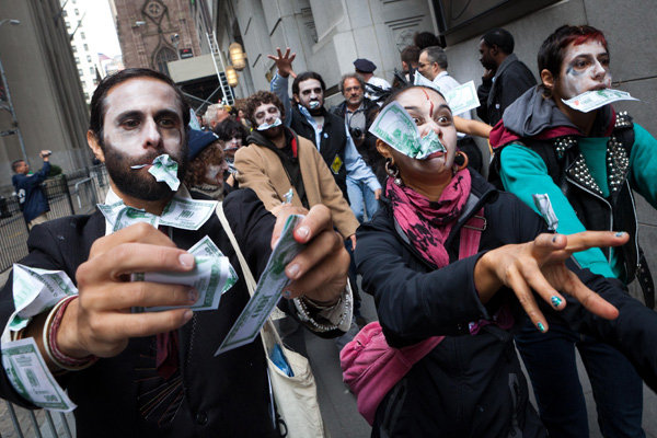 Protesters from Occupy Wall Street marching through New York's financial district dressed as "corporate zombies" on Monday.