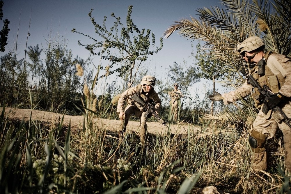 US Marines from Alpha Co. 1-6th Marines Lance Cpl Brendan Hart (right), extends a hand to Lance Cpl Charles Dawe on March 24, 2010 in Afghanistan.