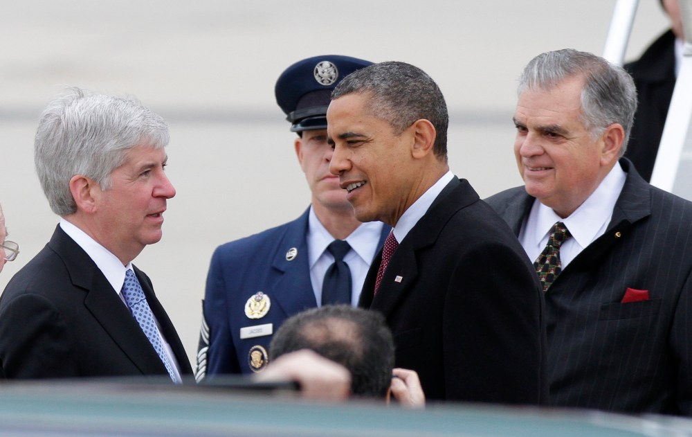 President Barack Obama was greeted by Michigan Gov. Rick Snyder hours before he criticized right-to-work legislation Snyder has helped push through the State House in the last week (Photo by Duane Burleson/AP)