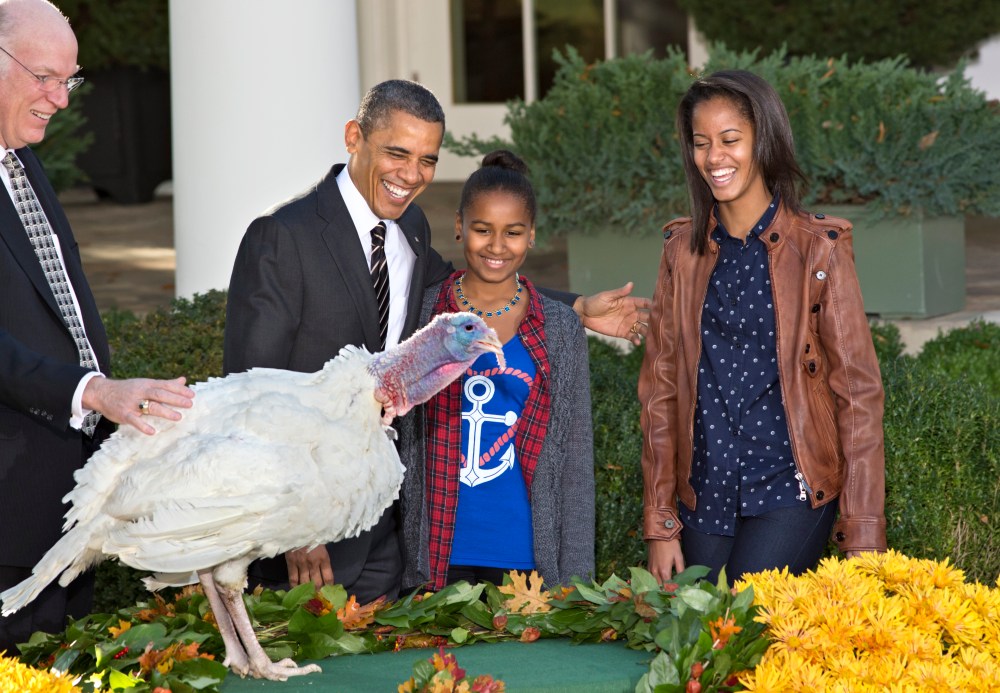 President Barack Obama, with daughters Sasha, center, and Malia, right, carries on the Thanksgiving tradition of saving a turkey from the dinner table with a "presidential pardon," at the White House in Washington, Wednesday, Nov. 21, 2012.  After the...