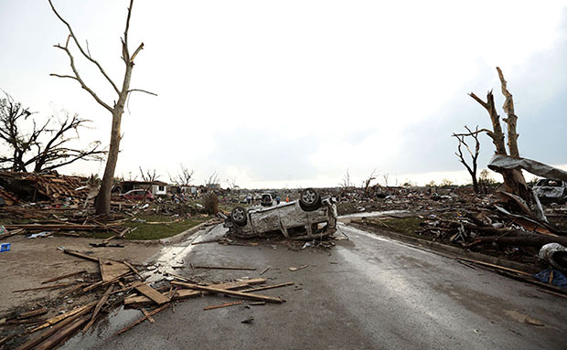 A vehicle lies upside down in the road after a powerful tornado ripped through the area on May 20, 2013 in Moore, Oklahoma. The tornado, reported to be at least EF4 strength and two miles wide, touched down in the Oklahoma City area on Monday killing...