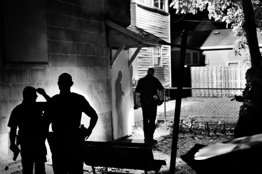Police officers search for a suspect in Rochester, NY, 2012.