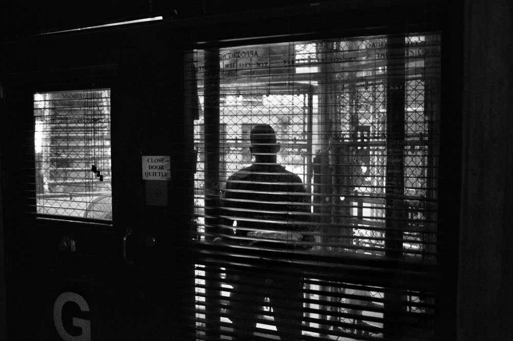 Views through the fenced-in guard post into the common area of a cell block in Camp 6 of Guantanamo Bay in 2012. (Photo by Paolo Pellegrin/Magnum Photos)