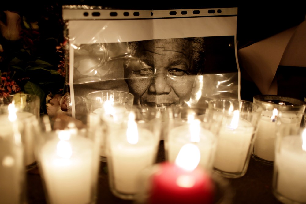 Flowers are layed on the ground in front of the South African Embassy in Paris a day after the death of former South African President Nelson Mandela on Dec. 6, 2013