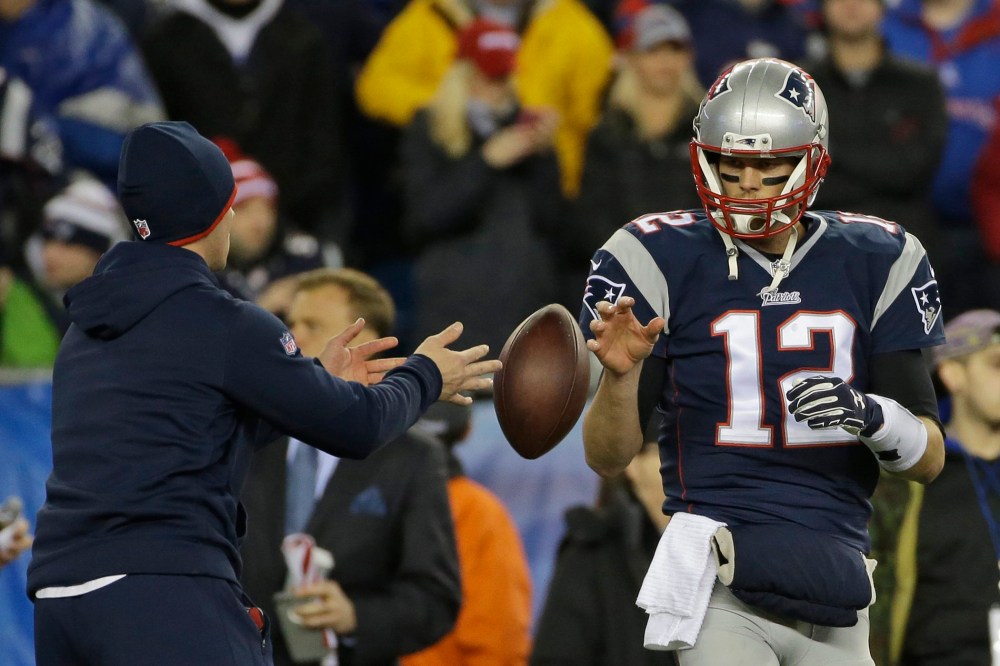 New England Patriots quarterback Tom Brady has a ball tossed to him during warmups before the NFL football AFC Championship game against the Indianapolis Colts in Foxborough, Mass. on Jan. 18, 2015. (Photo by Matt Slocum/AP)