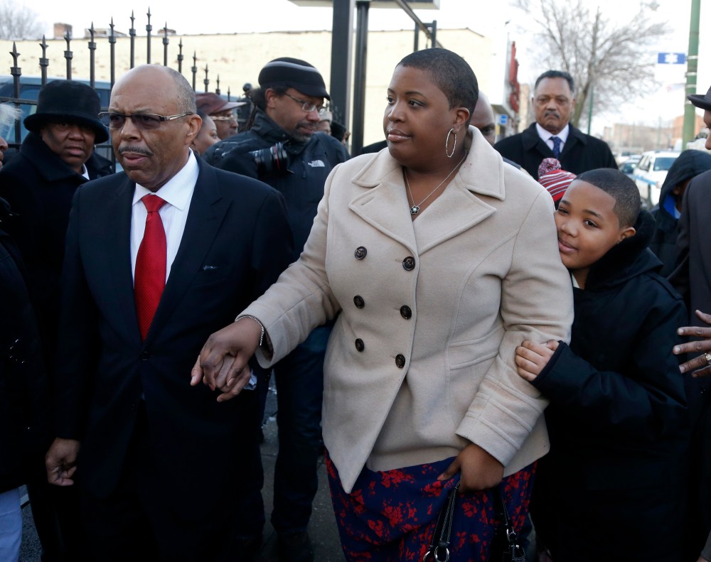 Funeral Director Edward Calahan left, escorts Cleopatra Pendleton and her son Nathaniel Jr. inside the funeral home for the wake of Mrs. Pendleton's daughter Hadiya Friday, Feb. 8, 2013, in Chicago. A White House official says Pendleton will attend the...